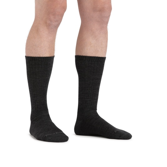 Man standing barefoot wearing The Standard Crew Lightweight Lifestyle Sock in Charcoal